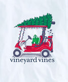 White long sleeve t-shirt with a red golf cart hauling a green Christmas Tree. The Vineyard Vines logo is below the illustration, and on the left sleeve.