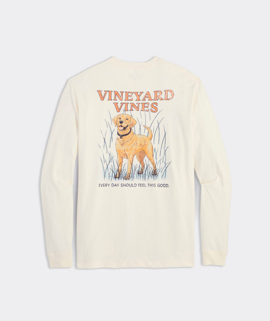 Long sleeve t-shirt with the graphic of a golden retriever dog on the back. Above the dogs is, "Vineyard Vines." Below the dog is the phrase, "EVERY DAY SHOULD FEEL THIS GOOD." The dog is standing in high grass, and the t-shirt is the color marshmallow.