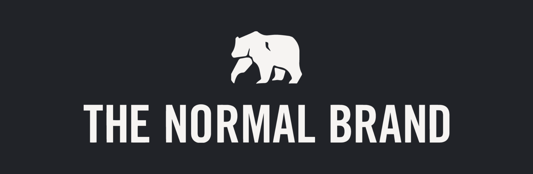 The Normal Brand logo in white with a background. Showing the graphic of a white bear on top.