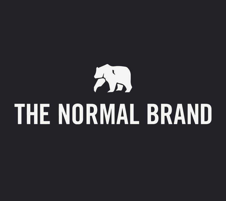 The Normal Brand logo in white with a background. Showing the graphic of a white bear on top.