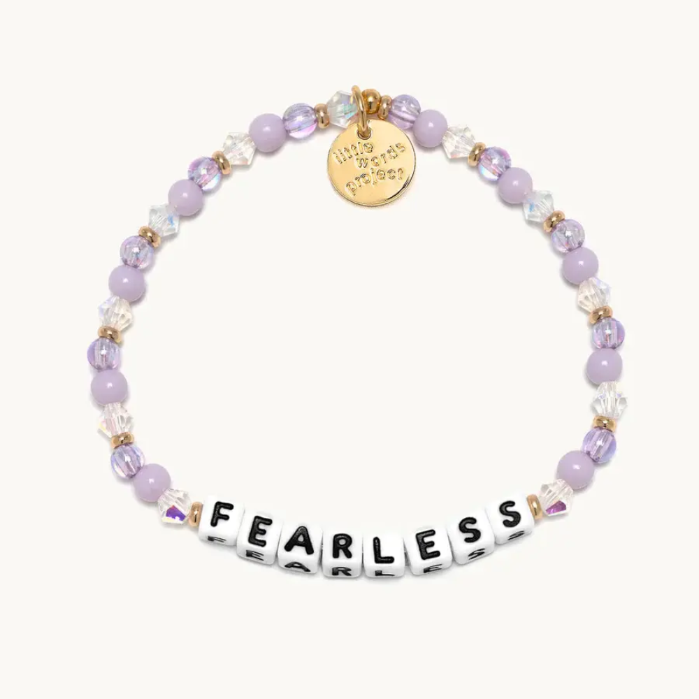 Pink color bead bracelet from Little Words Project that reads, "Fearless."