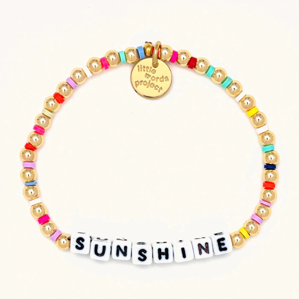 A 14k gold bead bracelet from Little Words Project that reads, "Sunshine."