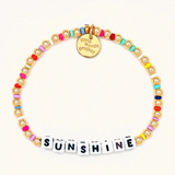 A 14k gold bead bracelet from Little Words Project that reads, "Sunshine."