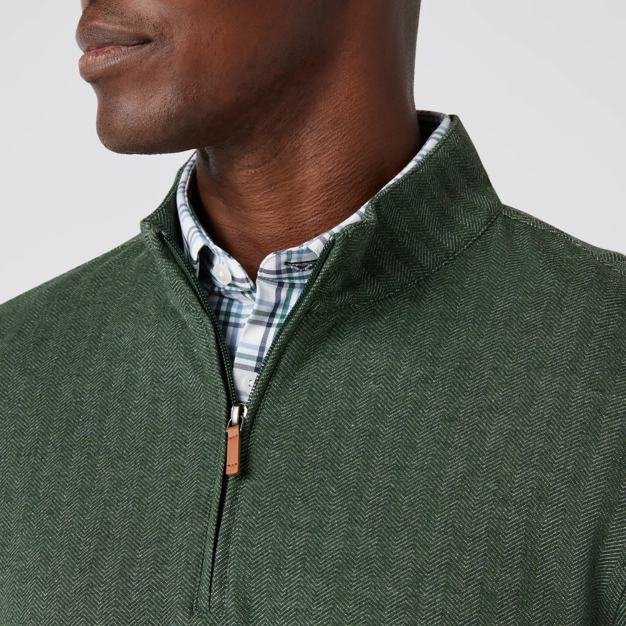 Green men's golf quarter-zip sweater from the brand Mizzen+Main.