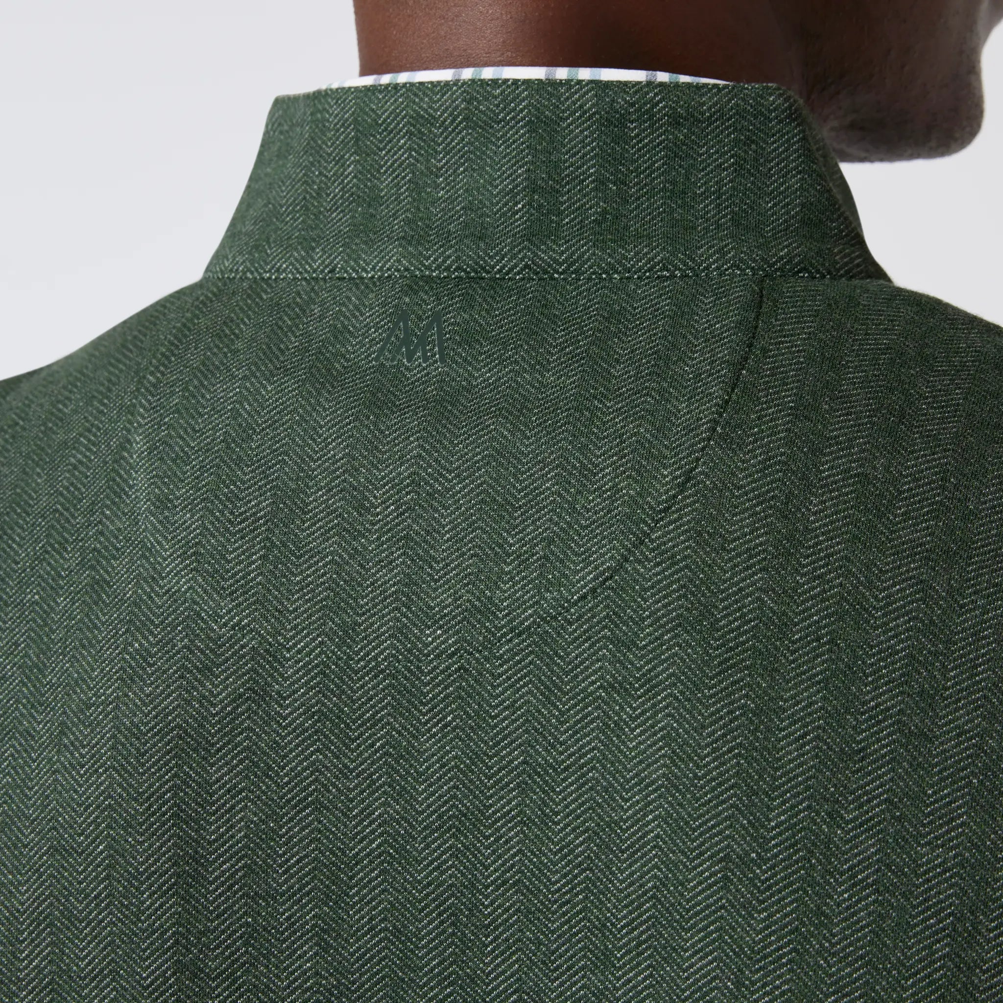 Green men's golf quarter-zip sweater from the brand Mizzen+Main.