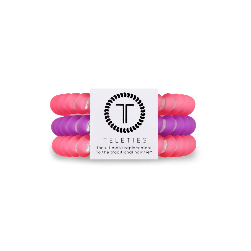 A pack of 3 small hair ties. One purple, two pink. From TELETIES.
