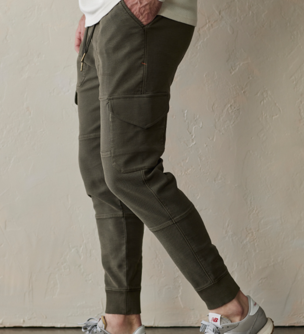 Side view of the Comfort Terry Jogger pant in color dusty olive green from The Normal Brand. Showing a side leg pocket.