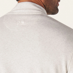 A close up of the back side of a Puremeso button popover shirt from The Normal Brand. The back of the shirt shows The Normal Brand bear logo.