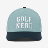 TravisMathew hat that reads, Golf Nerd, in the color blue, with a darker shade of blue on the bill of the cap.