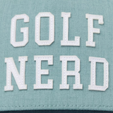 TravisMathew hat that reads, Golf Nerd, in the color blue, with a darker shade of blue on the bill of the cap.