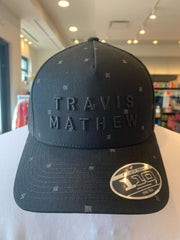 TravisMathew Shipwreck Beach Snapback Hat in the color black.