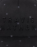 TravisMathew Shipwreck Beach Snapback Hat in the color black.