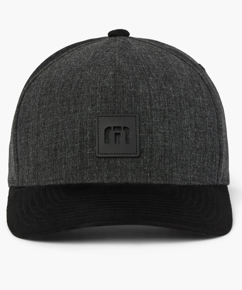 An all black golf hat from TravisMathew. Showing an all black bill, and black TravisMathew logo.