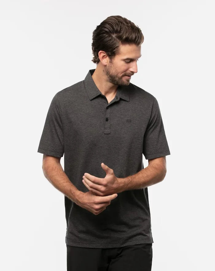 TravisMathew men's The Zinna Polo in the color heather black.