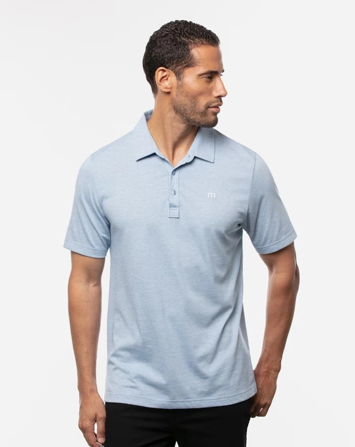 TravisMathew Men's The Zinna Polo in the color heather light blue.