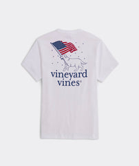 A Vineyard Vines pocket t-shirt showing a dog carrying an American flag in it's mouth.