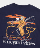 Navy blue Vineyard Vines men's t-shirt with a skeleton fishermen riding an orange Vineyard Vines logo.