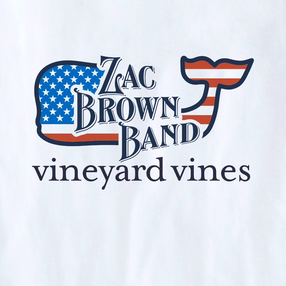 Limited edition Vineyard Vines t-shirt in the color white, with an American Flag Vineyard Vines logo whale on the back with The Zac Brown Band logo over top of the whale. The Vineyard Vines name is shown just below the whale.