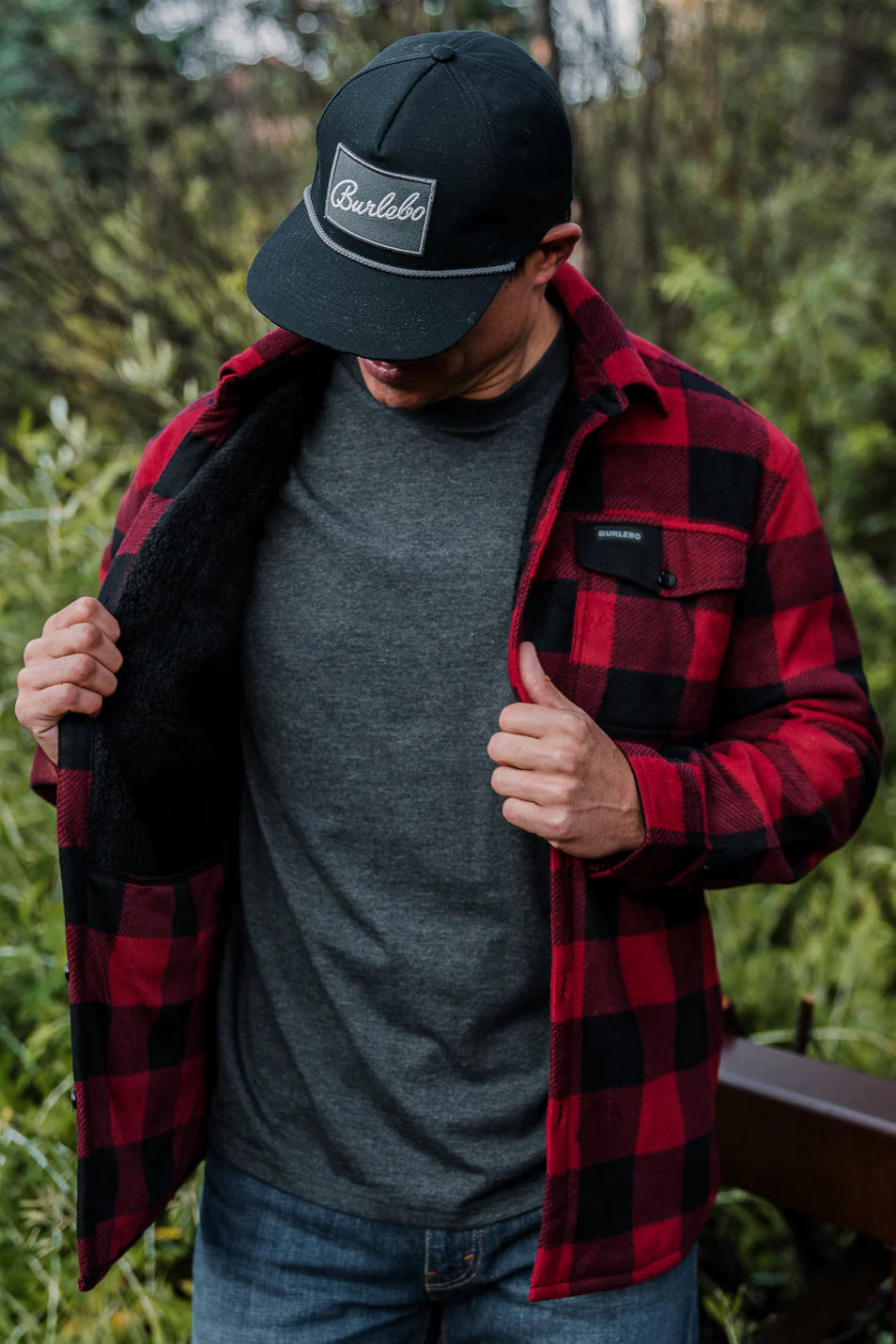 A red plaid shacket being worn by a Burlebo model with a Burlebo hat on.