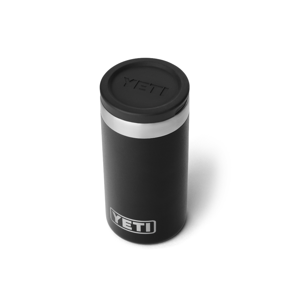 The top view of a black shot glass travel case, showing a black lid with a black YETI logo engraved into the lid. Also a silver YETI logo on the front of the case.