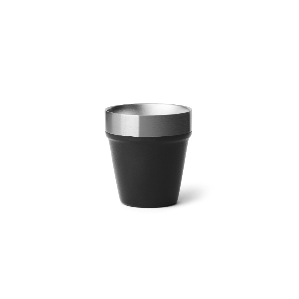 A black shot glass with a stainless steel rim on the top.