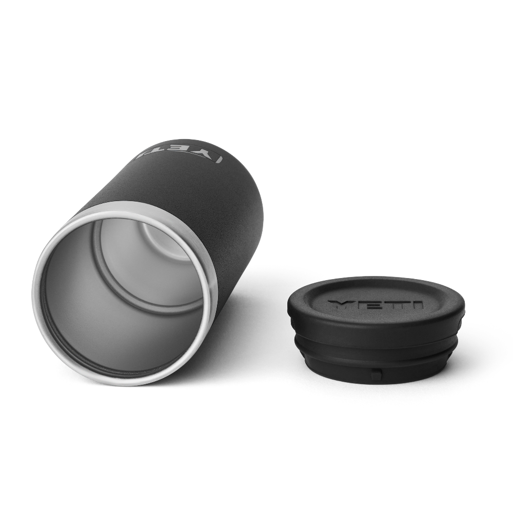 A black shot glass case on its side showing a stainless steel interior, and a black lid with the YETI logo engraved into the top.