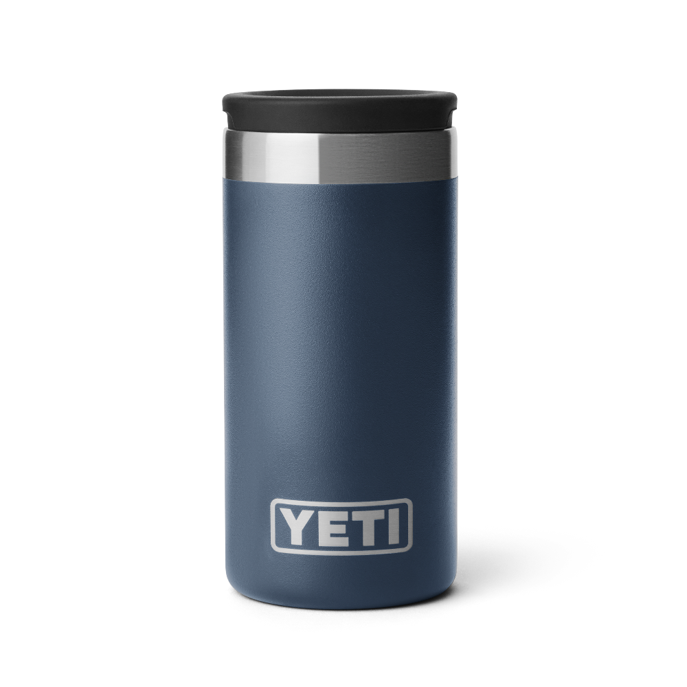 A navy blue shot glass travel case with a stainless steel rim a the top, and a black lid. Showing a silver YETI logo on the front of the case.