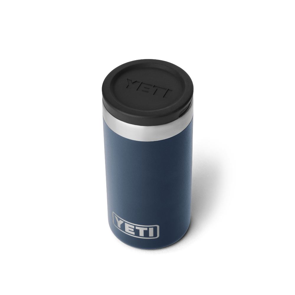 The top view of a navy blue shot glass travel case, showing a black lid with a black YETI logo engraved into the lid. Also a silver YETI logo on the front of the case.