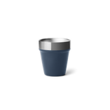 A navy blue shot glass with a stainless steel rim on the top.