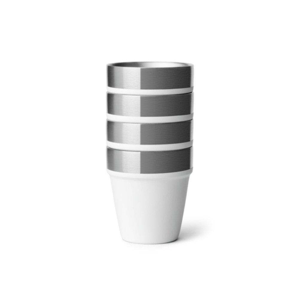 4 white shot glasses stacked on top of one another.