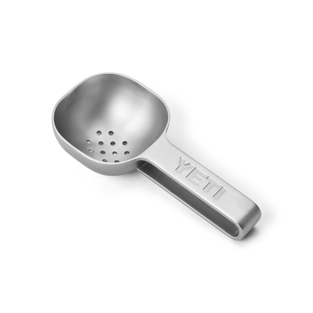 Stainless steel YETI ice scooper with drain holes.