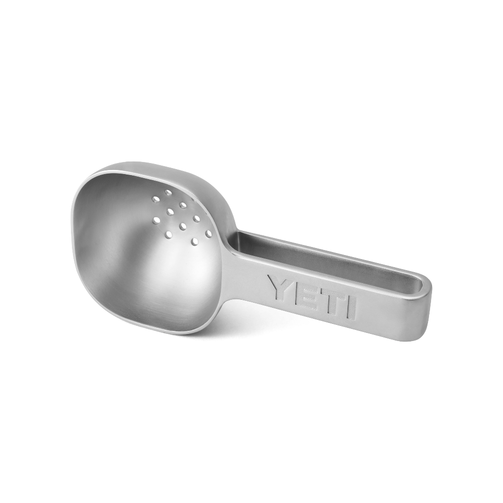 Stainless steel YETI ice scooper with drain holes.