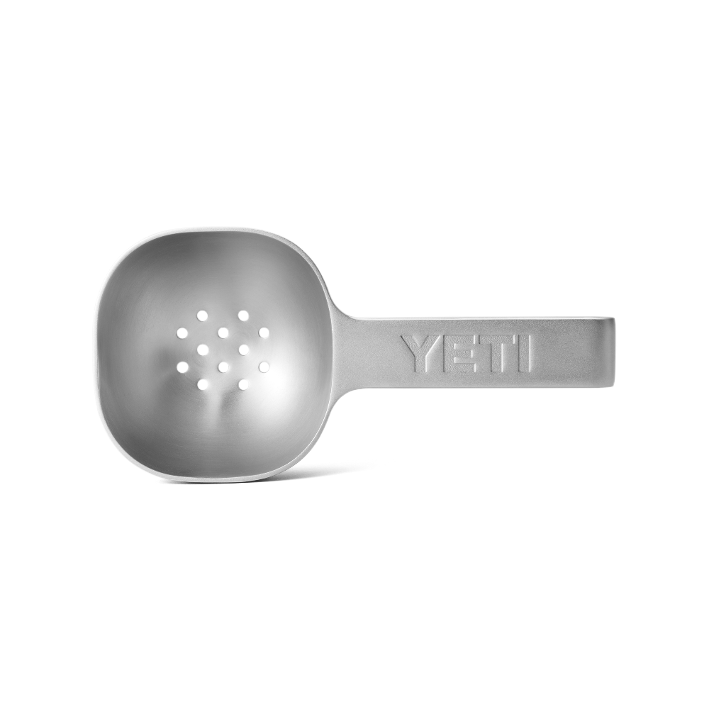 Stainless steel YETI ice scooper with drain holes.