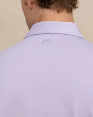 The back view of the Southern Tide brrr eeze Heather Performance Polo Shirt by Southern Tide - Heather Orchid Peta