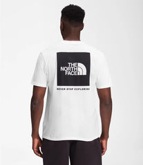 North Face Men's Short Sleeve Box NSE Tee In White, showing the back logo graphic that reads "The North Face, never stop exploring."