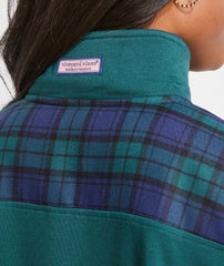 Plaid pattern on the back of the shep shirt. 