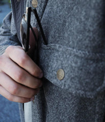 Close up of a men's shacket pocket with glasses